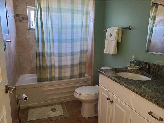 This is the en-suite bath for the second bedroom. - Single Family Home for sale at 1900 Illinois Ave, Englewood, FL 34224 - MLS Number is D6121965