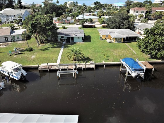57ft of waterfront with 48ft dock and boat lift - Single Family Home for sale at 1345 Holiday Dr, Englewood, FL 34223 - MLS Number is C7449205