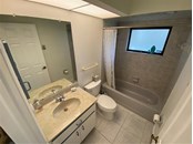Guest bathroom that has a tub/shower combo. - Single Family Home for sale at 18506 Hottelet Cir, Port Charlotte, FL 33948 - MLS Number is C7452138