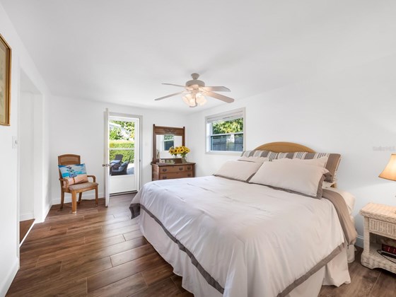 Large bedroom looking out into the spacious fenced backyard with patio and privacy. - Single Family Home for sale at 741 Fox St, Longboat Key, FL 34228 - MLS Number is A4520104