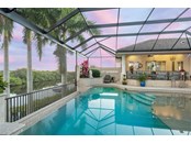 Enjoy the tranquil backdrop after a day at the office or beach by enjoying these amazing water views from the salt gas heated pool - Single Family Home for sale at 1012 Bayview Dr, Nokomis, FL 34275 - MLS Number is A4521028