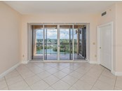 Great room with sliders to the balcony. Master bedroom door is on the right. - Condo for sale at 147 Tampa Ave E #702, Venice, FL 34285 - MLS Number is N6116949